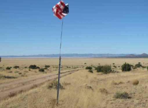 Placing the flag on the way up Gray Hill.JPG