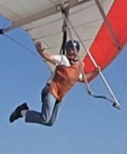 PositionHandFreeWavingWhileOtherHandOnDowntubeHeadTurnedToSpectator.JPG